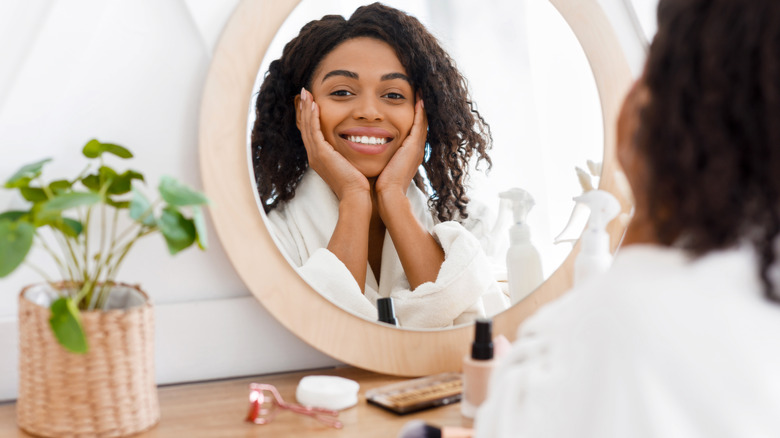 Woman applying skin care product 