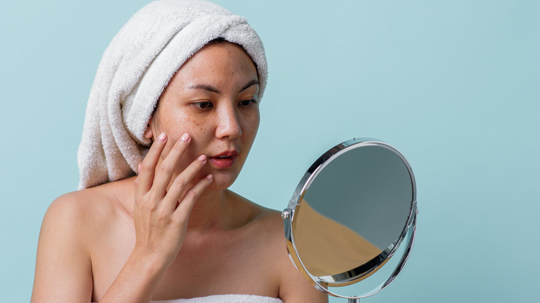 Woman applying skin care 