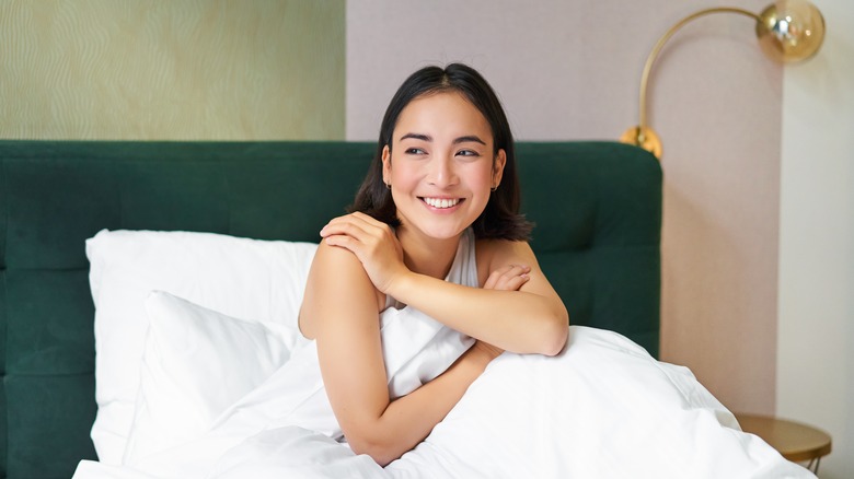 woman smiling in bed