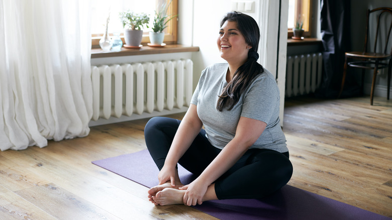 Stretching on yoga mat