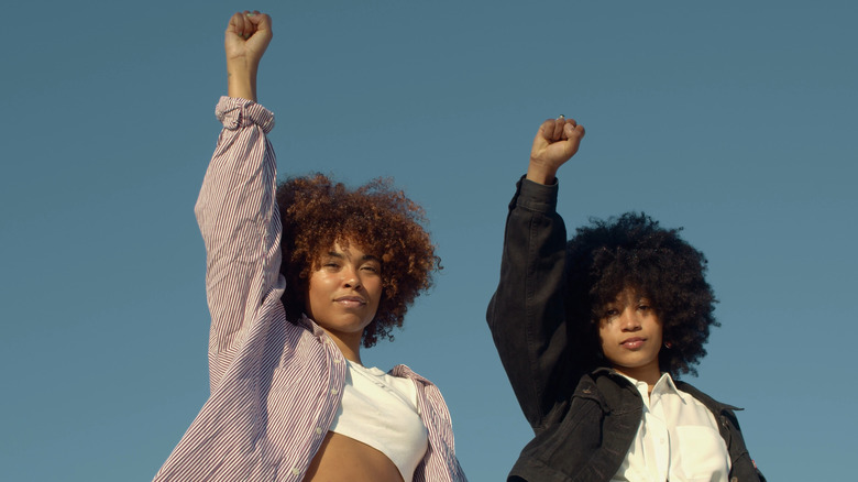 Two women holding up their fists