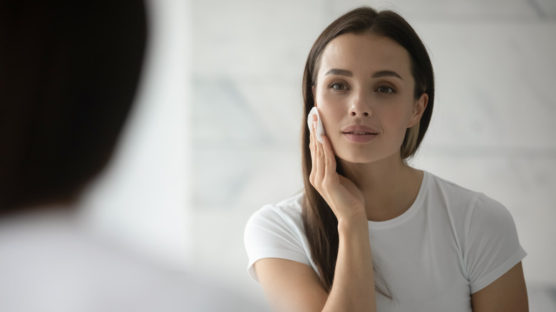 A woman cleansing her face