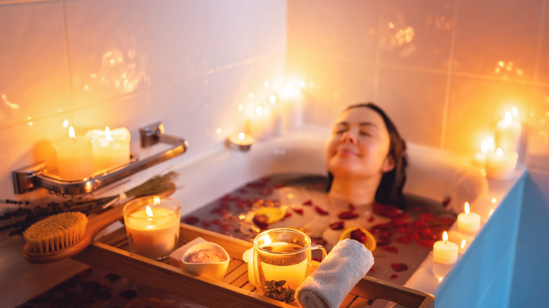 A woman smiling in a bath 