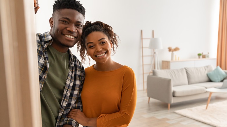 couple smiling and linking arms