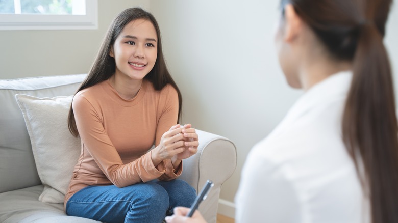 Young woman talking to therapist