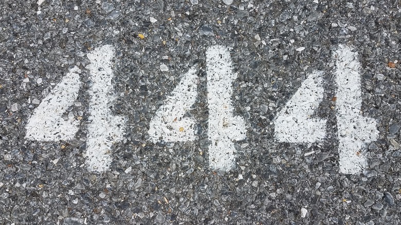 Number 444 painted onto asphalt 