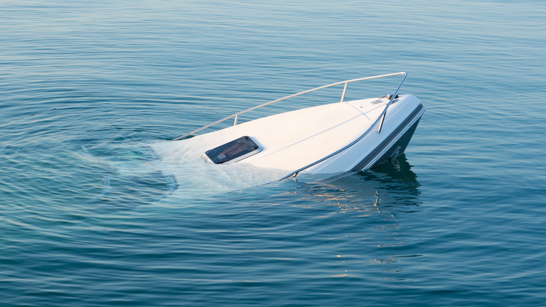 A white boat sinking