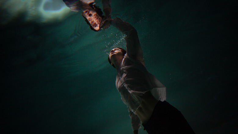 A clothed person underwater 