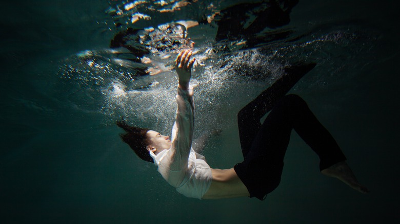 A clothed person underwater 
