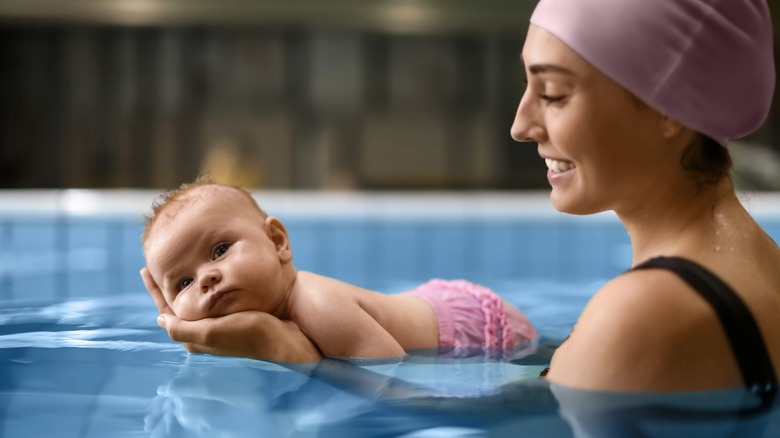 Woman with a baby in swimming pool