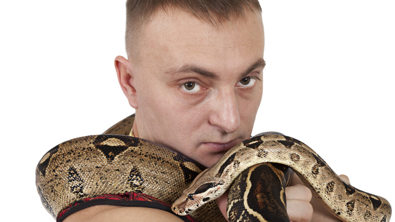 Man with snake around neck