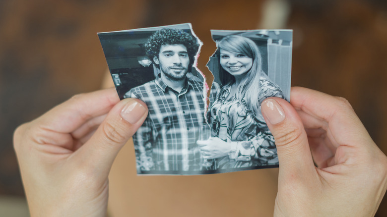 holding cut picture of couple 