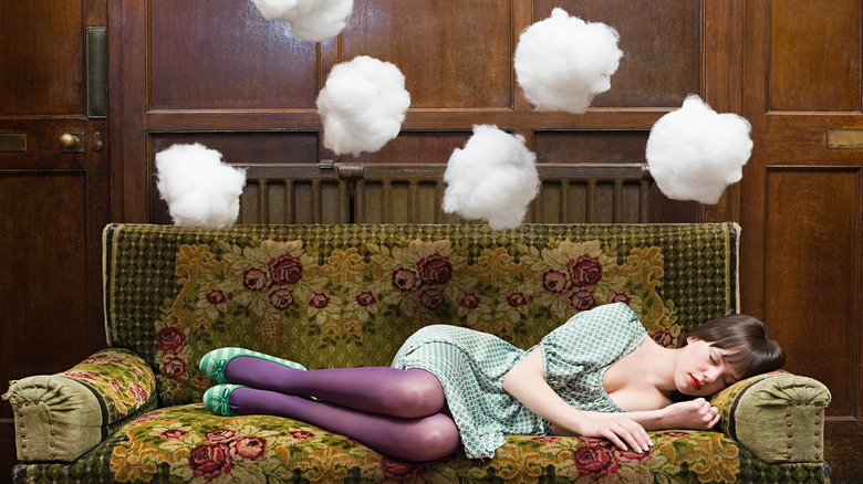 A woman on a couch, dreaming 