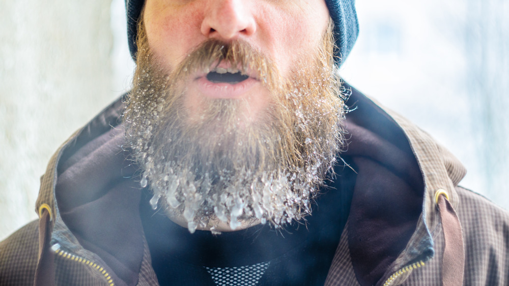 a man out in the cold with ice crystals stuck to his beard