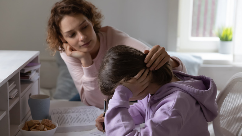 Mother comforting daughter