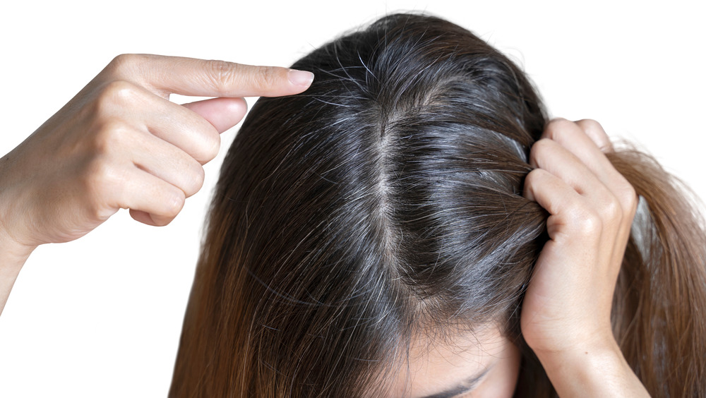 Woman showing hair and scalp roots