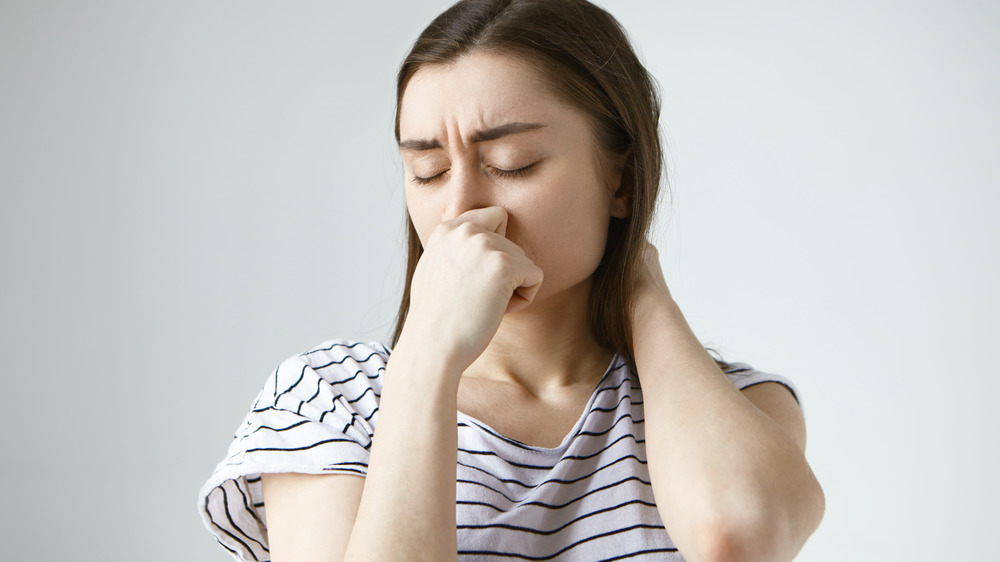 Woman stopping her nosebleed