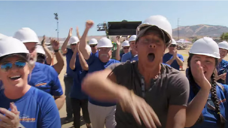 Ty Pennington leading a group of volunteers on Extreme Makeover Home Edition