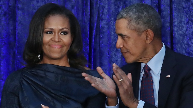 Barack Obama applauding Michelle Obama