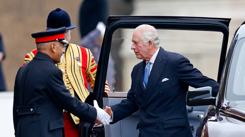 Guard shaking King Charles' hand