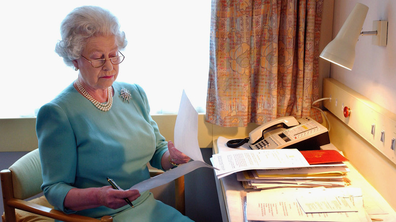 Queen Elizabeth working on train