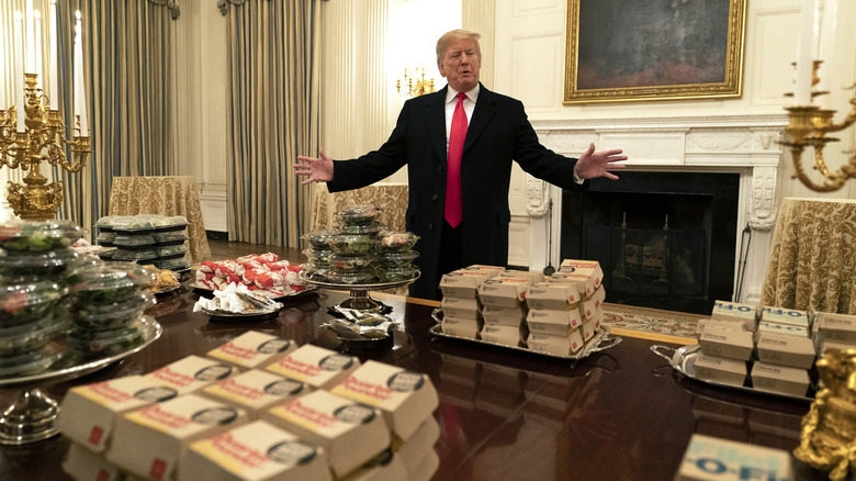 Donald Trump behind a table full of fast food