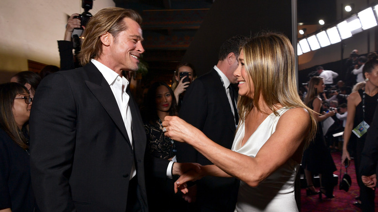 Brad Pitt and Jennifer Aniston greet each other at an event