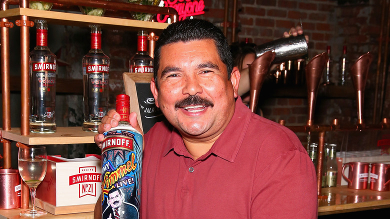 Guillermo Rodriguez smiles with a bottle of "Jimmy Kimmel Live" Smirnoff vodka