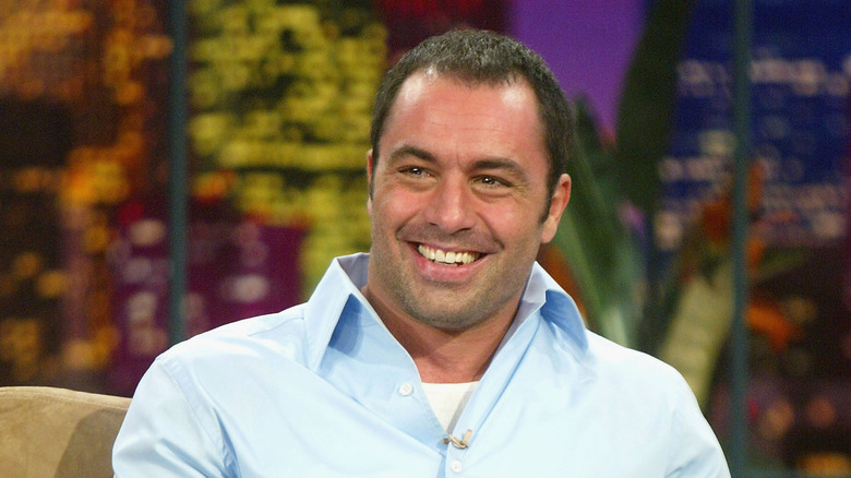 Joe Rogan smiling in a blue shirt