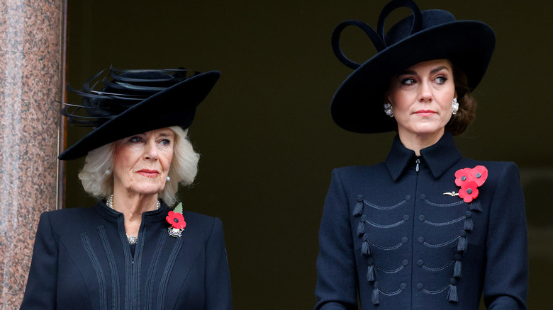 Kate Middleton and Queen Camilla looking at an event