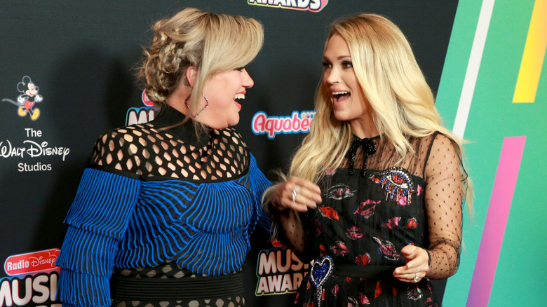 Kelly Clarkson and Carrie Underwood laughing