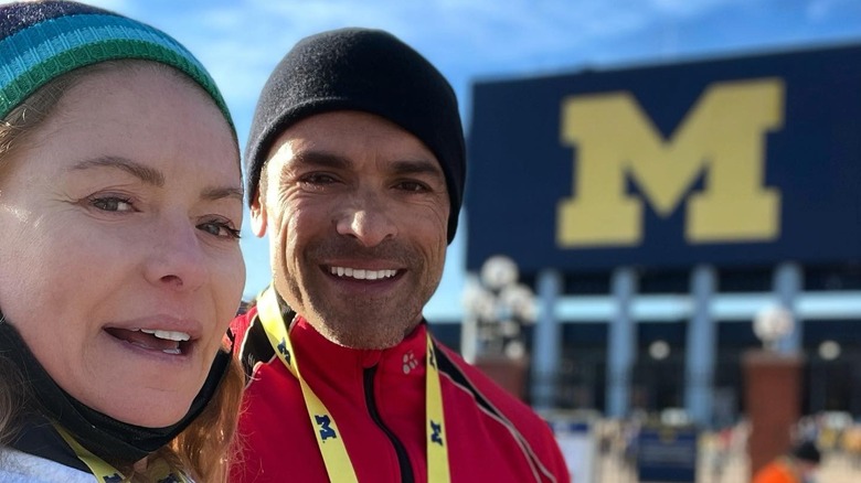 Kelly Ripa posing with Mark Consuelos following a 5K race