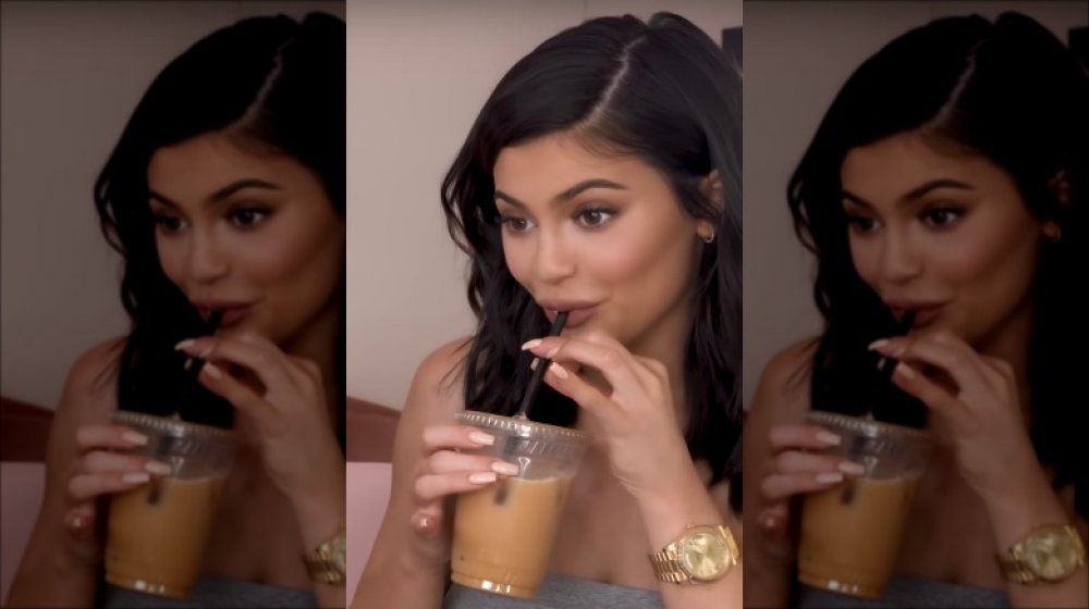 Kylie Jenner drinking iced coffee, something she often drinks in a day