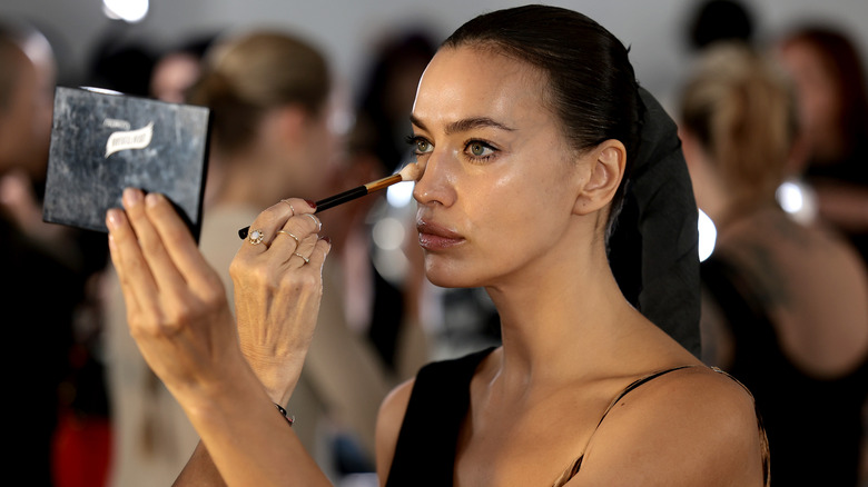 Irina Shayk applying makeup