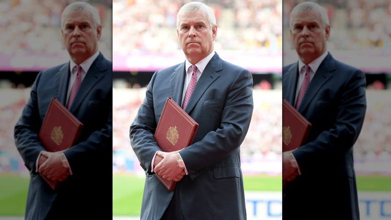 Prince Andrew posing with book