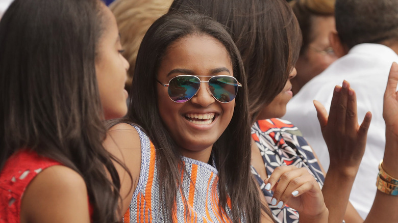 Sasha Obama laughing in sunglasses