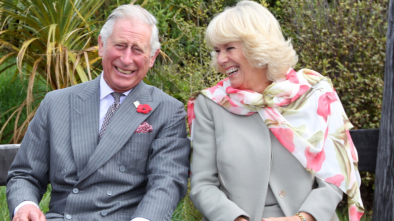 King Charles III and Camilla, Queen Consort laughing 