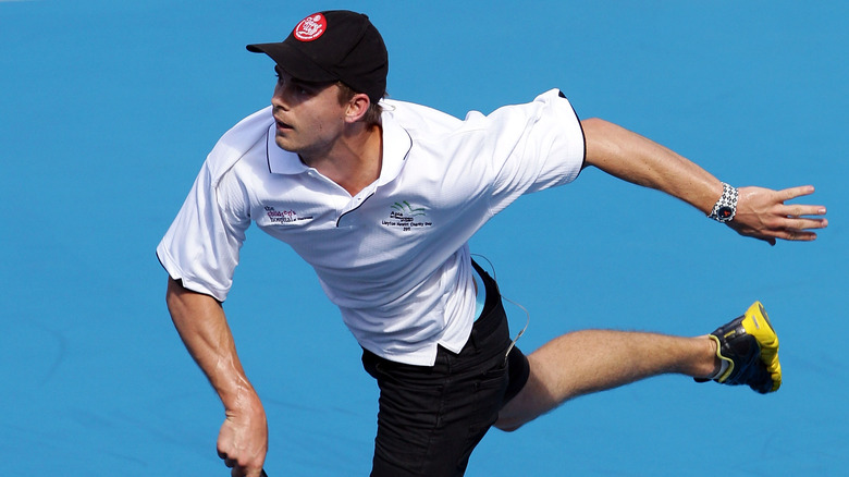 Luke Mitchell playing tennis