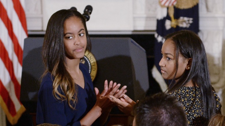 Malia and Sasha Obama at a ceremony in the White House