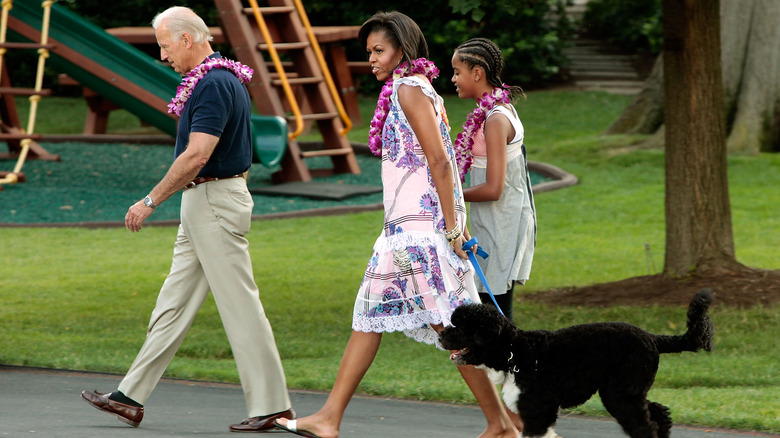 Joe Biden, Michelle and Malia Obama walking