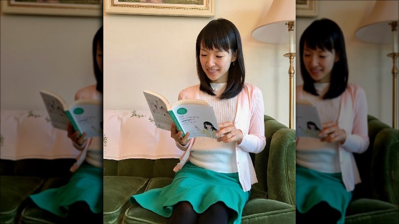 Marie Kondo reading her book at home