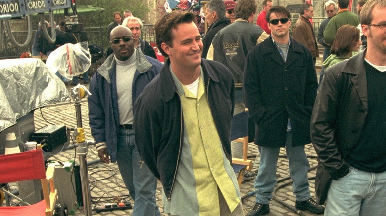 Matthew Perry smiling on Friends set