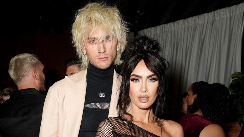 Machine Gun Kelly posing alongside Megan Fox.