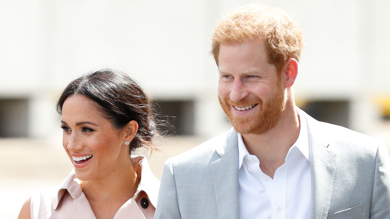 Meghan Markle and Prince Harry walking and smiling