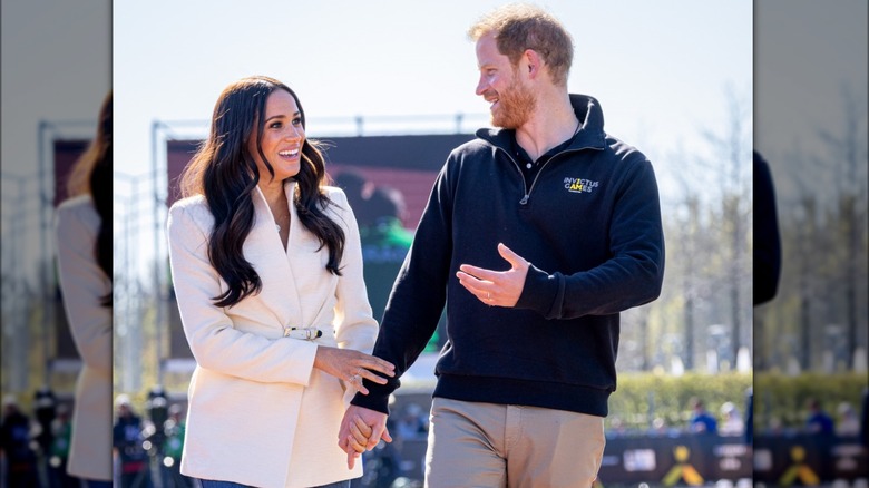 Meghan Markle and Prince Harry holding hands in public