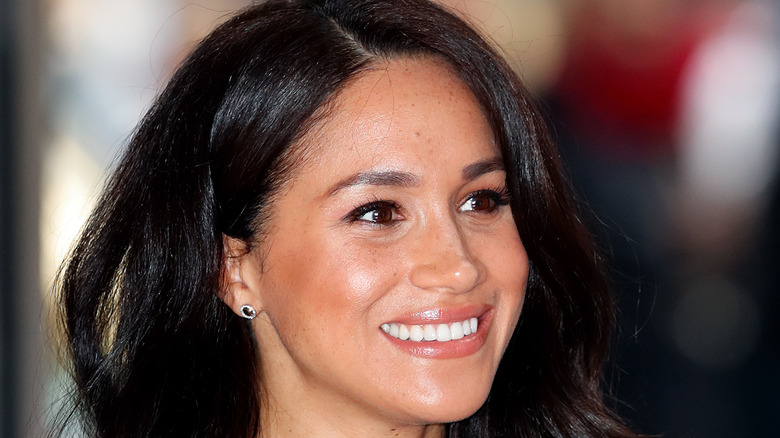 Meghan Markle smiling at an event