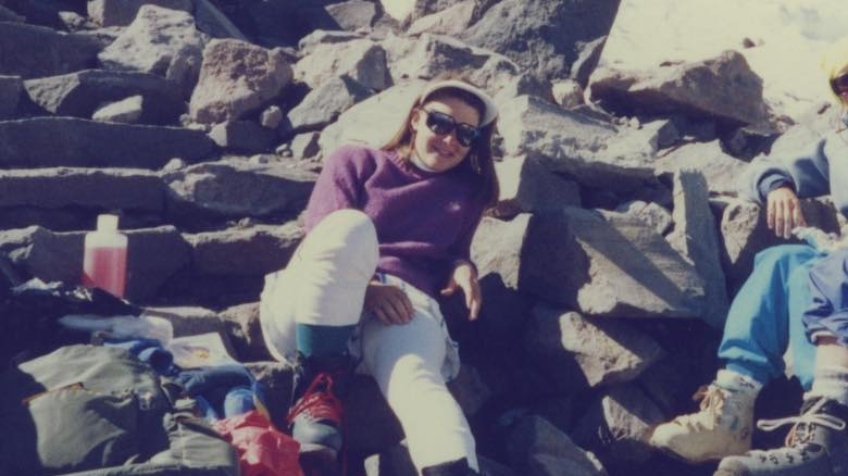 Melinda Gates sitting on rocks