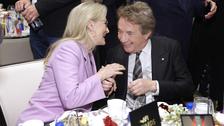 Meryl Streep and Martin Short talking at a dinner