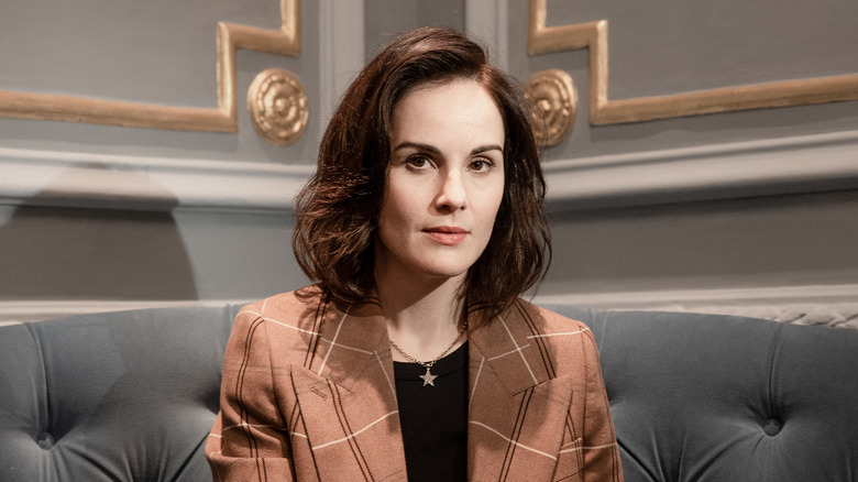 Michelle Dockery sitting on a sofa