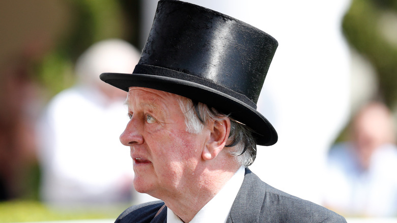 Andrew Parker Bowles in a top hat looking away